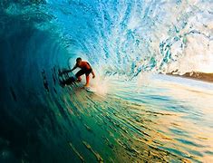 A man riding on top of a wave in the ocean.