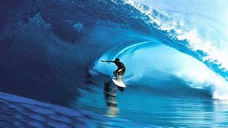 A man riding on top of a surfboard in the ocean.